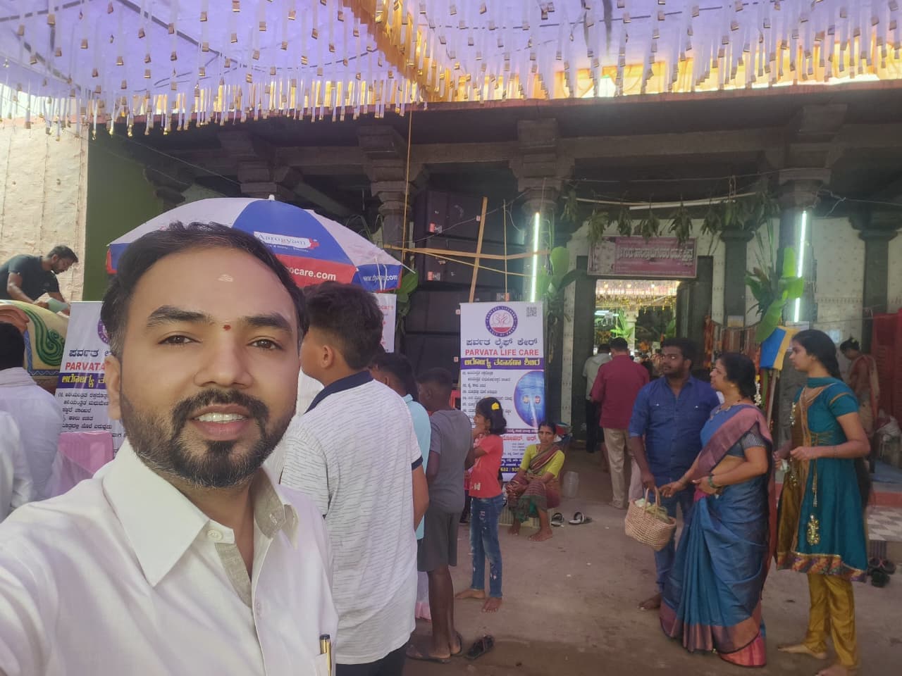 Tattva Foundation lead coordinator organizing registrations at temple courtyard camp